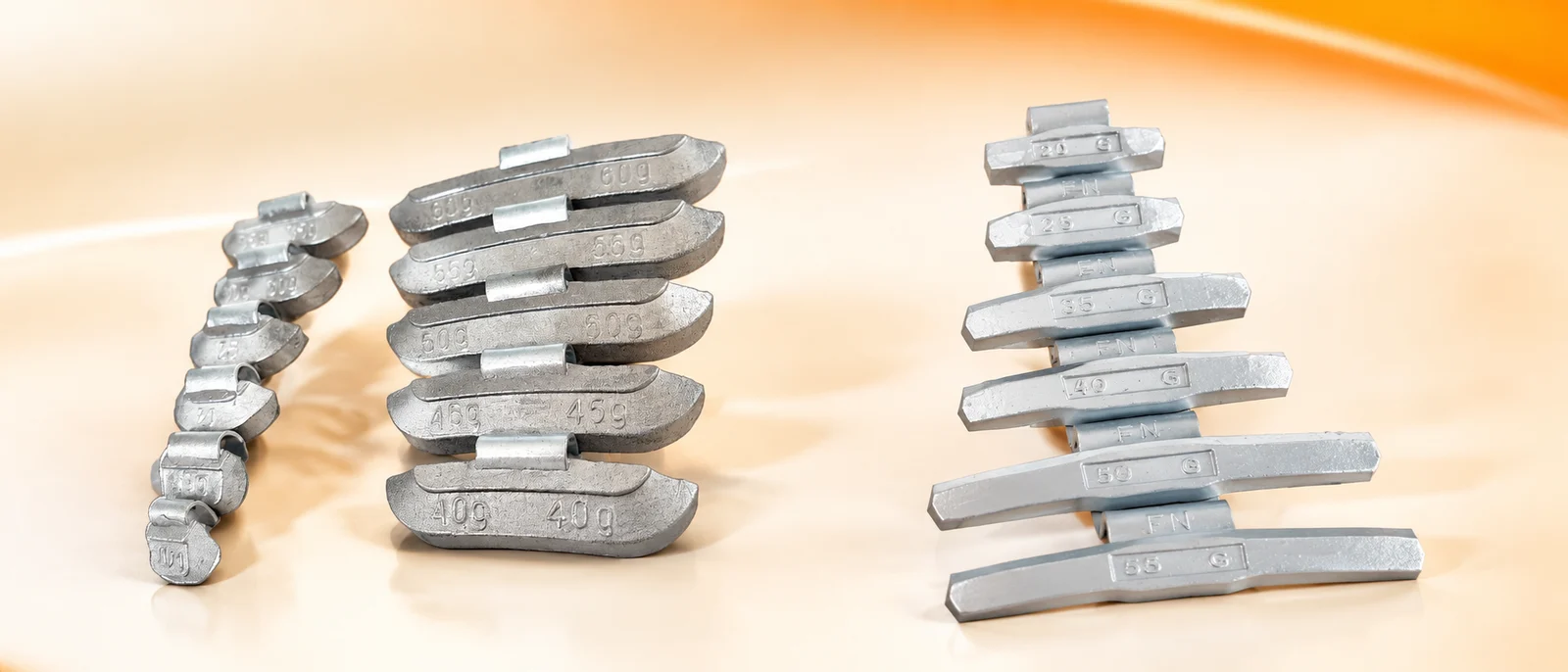 Lead clip-on wheel balancing weights next to coated steel alternatives