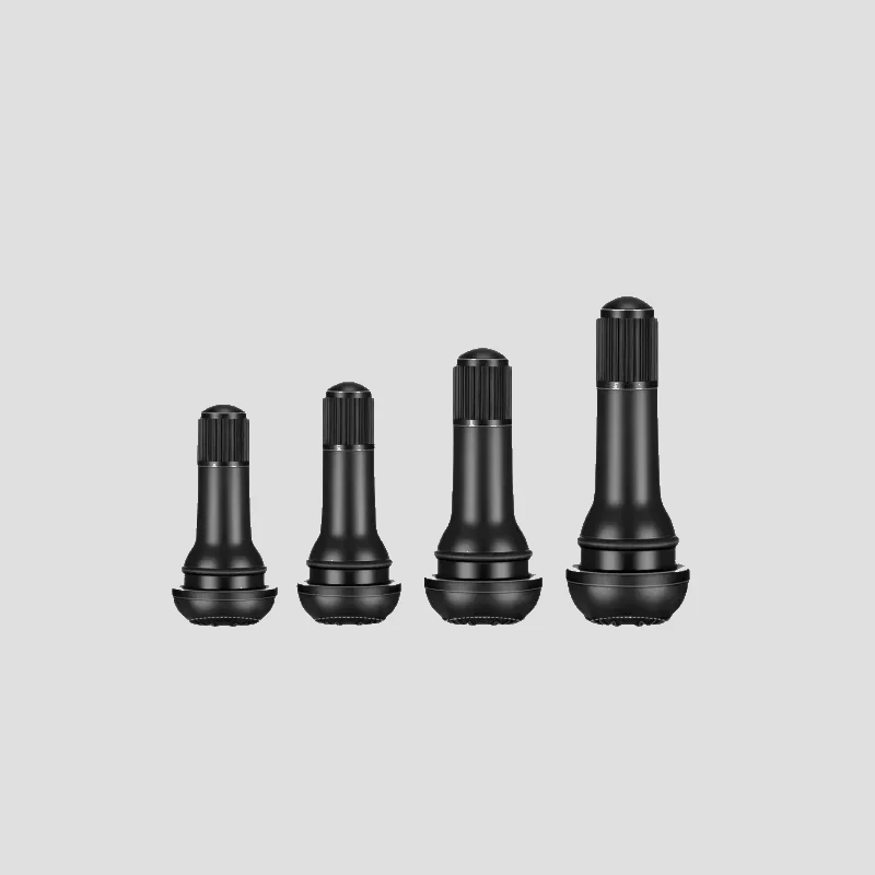 Four rubber snap-in tyre valve stems with black dome caps fitted